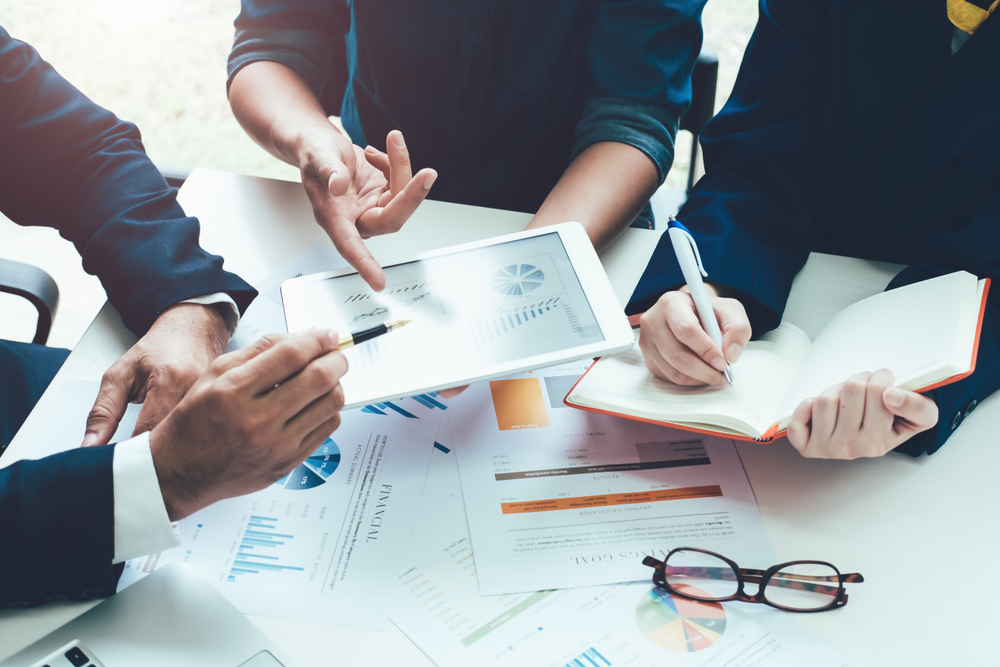 1 Asian business adviser meeting to analyze and discuss the situation on the financial report in the meeting room.Investment Consultant,Financial Consultant,Financial advisor