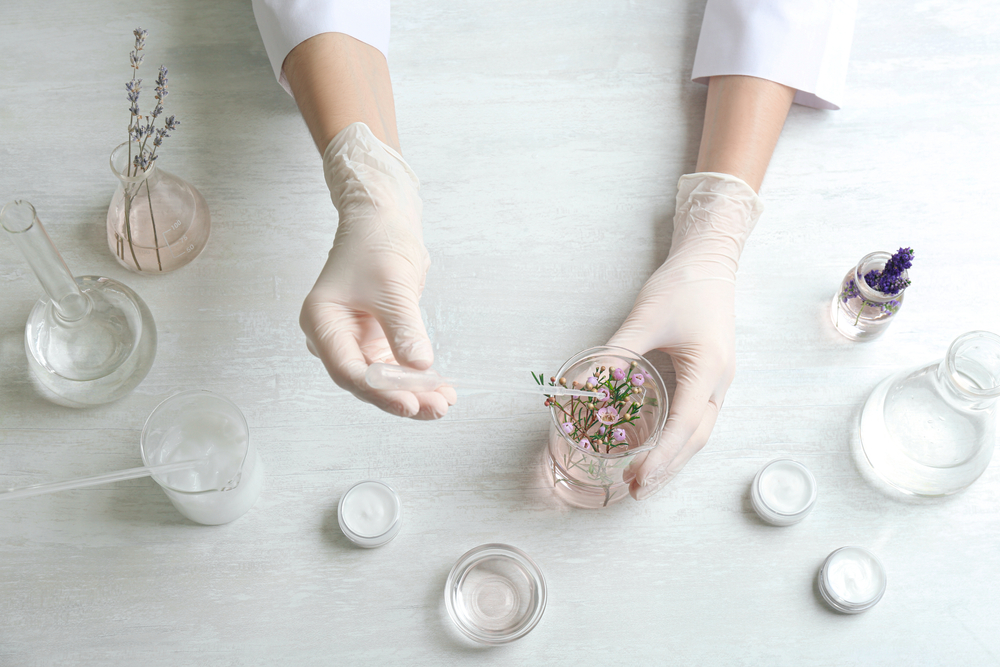 Scientist developing cosmetic product in laboratory, top view